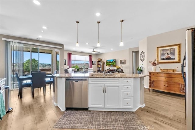 11444 River Run St, Apple Valley, CA 92308 - kitchen with stainless steel appliances, white cabinets, light wood-style floors, decorative light fixtures, and recessed lighting