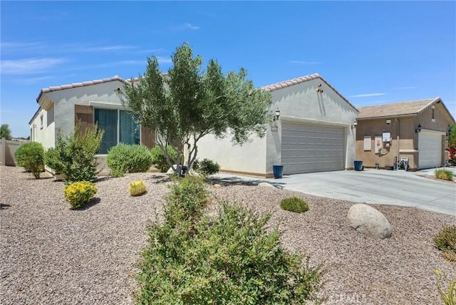 11444 River Run St, Apple Valley, CA 92308 - view of front of house featuring an attached garage, driveway, stucco siding, and a tile roof