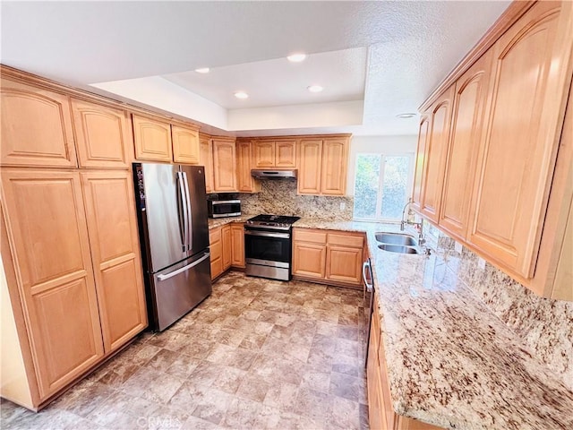 10349 Victoria St, Rancho Cucamonga, CA 91701 - kitchen with appliances with stainless steel finishes, a tray ceiling, light brown cabinetry, under cabinet range hood, and tasteful backsplash