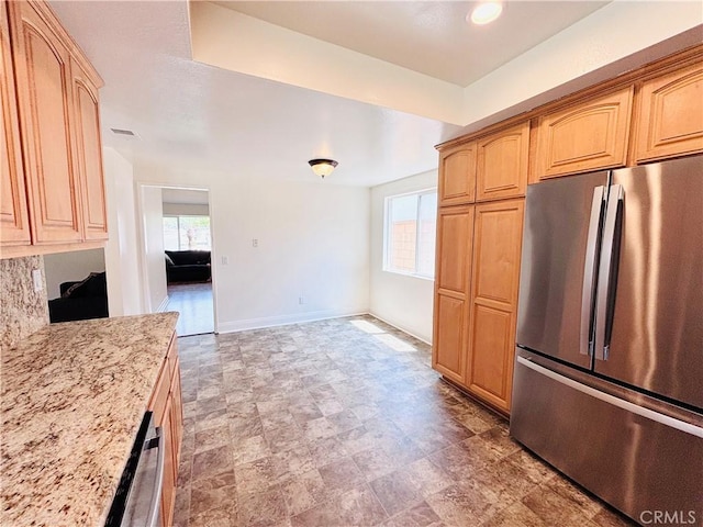 10349 Victoria St, Rancho Cucamonga, CA 91701 - kitchen featuring freestanding refrigerator, plenty of natural light, light stone countertops, and light brown cabinetry