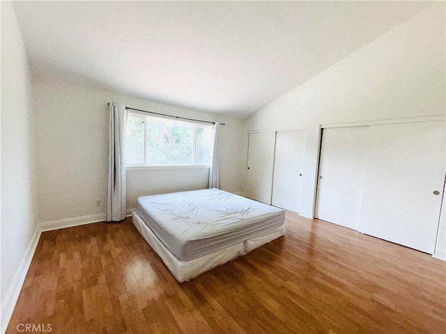 10349 Victoria St, Rancho Cucamonga, CA 91701 - bedroom with two closets, wood finished floors, and vaulted ceiling