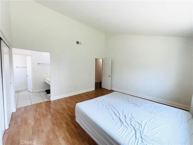 10349 Victoria St, Rancho Cucamonga, CA 91701 - bedroom featuring high vaulted ceiling, light wood-style floors, and ensuite bathroom