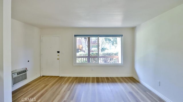 1000 W Macarthur Blvd Unit 57, Santa Ana, CA 92707 - unfurnished room featuring wood finished floors and a wall unit AC