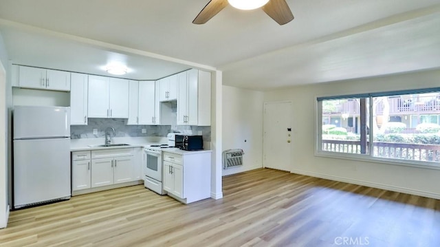 1000 W Macarthur Blvd Unit 57, Santa Ana, CA 92707 - kitchen featuring white appliances, ceiling fan, light wood finished floors, backsplash, and white cabinets