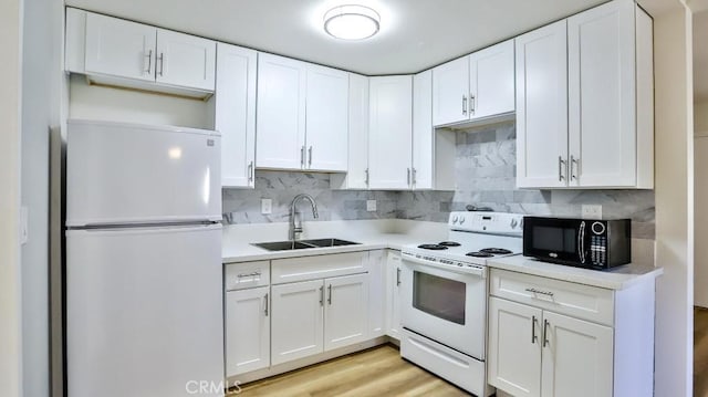 1000 W Macarthur Blvd Unit 57, Santa Ana, CA 92707 - kitchen featuring white appliances, white cabinetry, light countertops, backsplash, and light wood finished floors