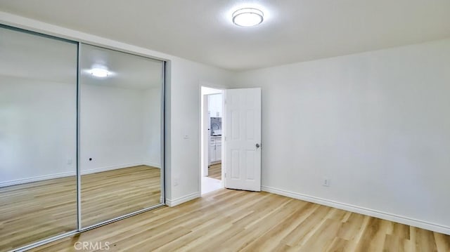 1000 W Macarthur Blvd Unit 57, Santa Ana, CA 92707 - unfurnished bedroom with wood finished floors and a closet