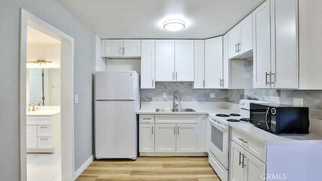 1000 W Macarthur Blvd Unit 57, Santa Ana, CA 92707 - kitchen featuring white appliances, white cabinets, tasteful backsplash, light countertops, and light wood-type flooring