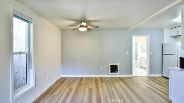 1000 W Macarthur Blvd Unit 57, Santa Ana, CA 92707 - unfurnished living room featuring a ceiling fan, light wood-style floors, and heating unit