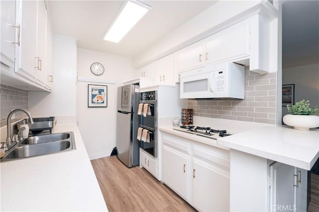 6160 Whitsett Ave Unit 4, North Hollywood, CA 91606 - kitchen featuring white appliances, light wood-style flooring, tasteful backsplash, and light countertops