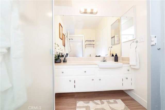 6160 Whitsett Ave Unit 4, North Hollywood, CA 91606 - bathroom featuring wood finished floors, vanity, and a shower with door