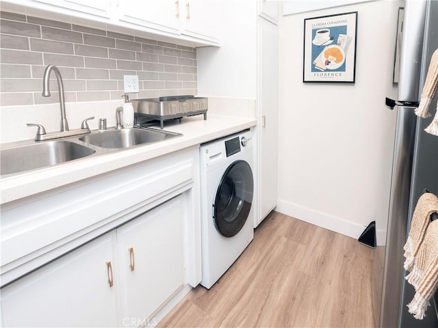 6160 Whitsett Ave Unit 4, North Hollywood, CA 91606 - laundry room featuring washer / clothes dryer, light wood-style floors, and cabinet space