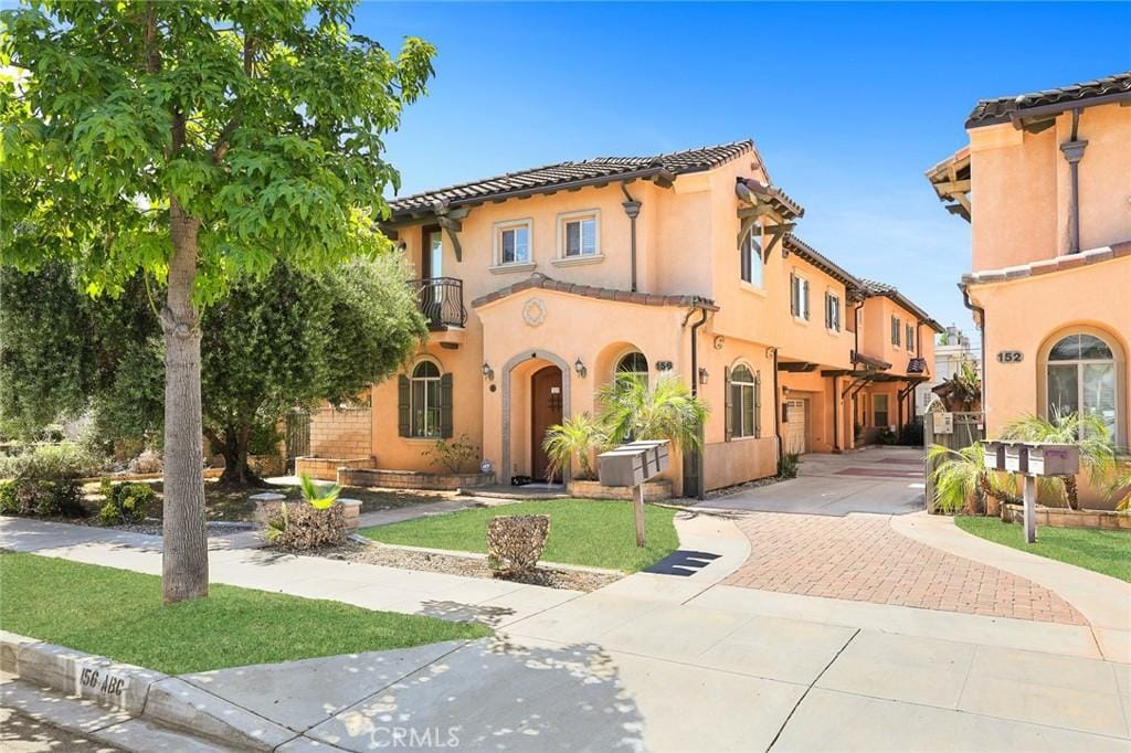 156 El Dorado St Unit B, Arcadia, CA 91006 - mediterranean / spanish-style house with a front lawn, a balcony, stucco siding, and a tile roof