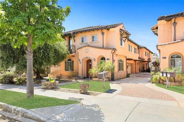 156 El Dorado St Unit B, Arcadia, CA 91006 - mediterranean / spanish-style house with a front lawn, a balcony, stucco siding, and a tile roof