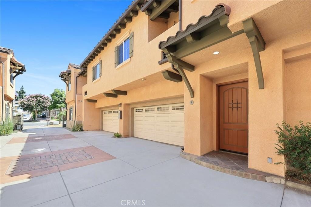 156 El Dorado St Unit B, Arcadia, CA 91006 - entrance to property with a garage, stucco siding, and concrete driveway