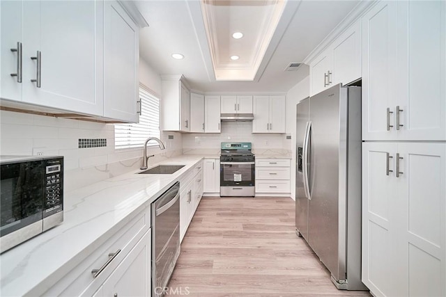 15832 Apollo Pl, Gardena, CA 90249 - kitchen with stainless steel appliances, light wood-type flooring, white cabinets, light stone counters, and recessed lighting