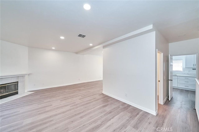 15832 Apollo Pl, Gardena, CA 90249 - unfurnished living room featuring light wood finished floors, recessed lighting, and a fireplace