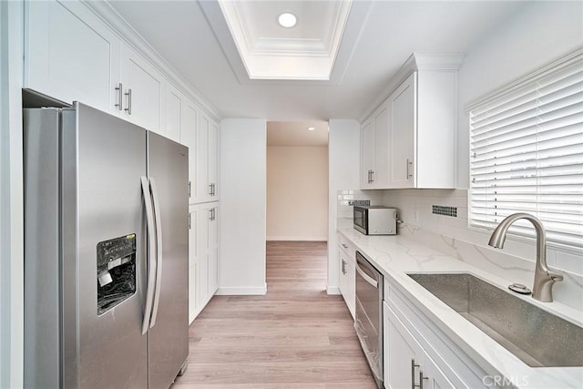 15832 Apollo Pl, Gardena, CA 90249 - kitchen featuring stainless steel appliances, a tray ceiling, white cabinetry, light wood-style flooring, and recessed lighting
