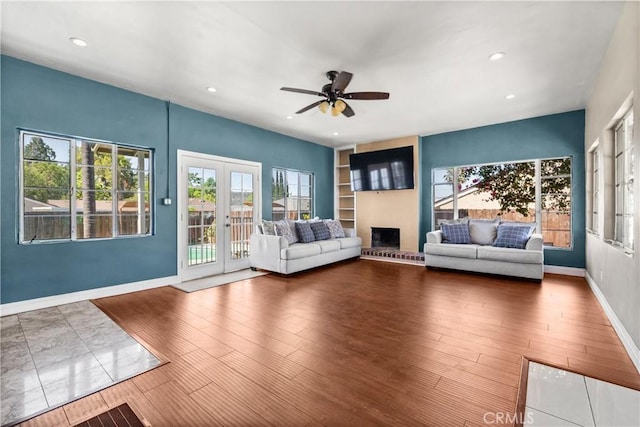 7314 Summitrose St, Tujunga, CA 91042 - living area featuring hardwood / wood-style flooring, a ceiling fan, recessed lighting, french doors, and a fireplace with raised hearth