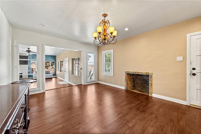 7314 Summitrose St, Tujunga, CA 91042 - unfurnished living room featuring plenty of natural light, a fireplace, wood finished floors, and a chandelier