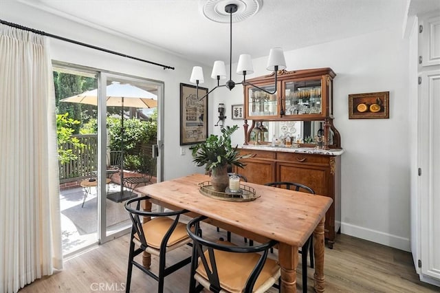 24754 Masters Cup Way, Valencia, CA 91355 - dining space with light wood-style flooring and bar area