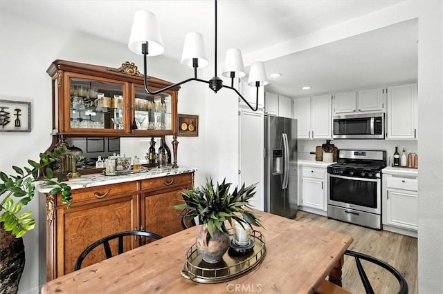 24754 Masters Cup Way, Valencia, CA 91355 - kitchen featuring appliances with stainless steel finishes, light countertops, light wood-type flooring, white cabinetry, and recessed lighting
