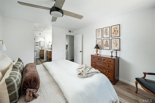 24754 Masters Cup Way, Valencia, CA 91355 - bedroom featuring attic access, wood finished floors, connected bathroom, and ceiling fan