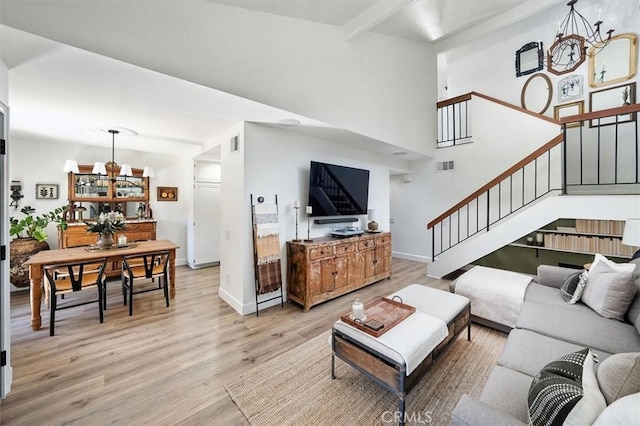 24754 Masters Cup Way, Valencia, CA 91355 - living area with stairs, light wood-style flooring, and a chandelier