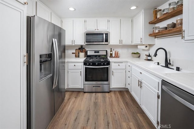 24754 Masters Cup Way, Valencia, CA 91355 - kitchen with appliances with stainless steel finishes, light countertops, white cabinets, and recessed lighting