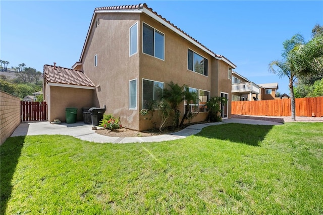 827 La Cadena Ln, Corona, CA 92879 - back of house featuring a tile roof, stucco siding, and a gate