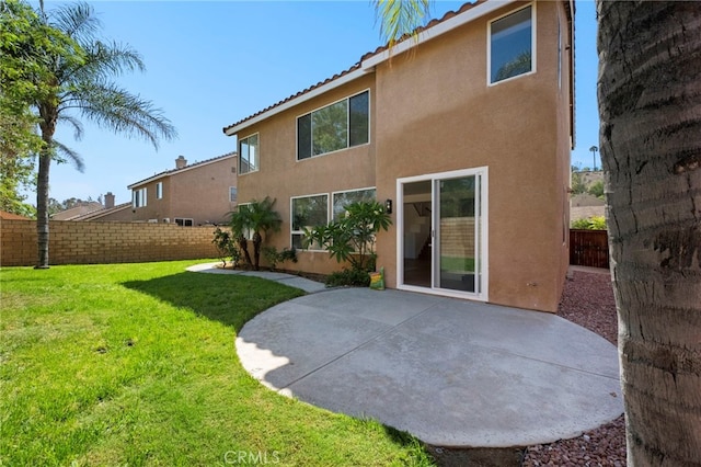 827 La Cadena Ln, Corona, CA 92879 - rear view of house featuring stucco siding, a patio, a fenced backyard, and a tile roof