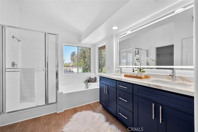 827 La Cadena Ln, Corona, CA 92879 - bathroom with vaulted ceiling, double vanity, a stall shower, a garden tub, and wood finished floors