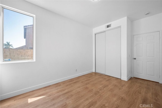 827 La Cadena Ln, Corona, CA 92879 - unfurnished bedroom with light wood finished floors and a closet