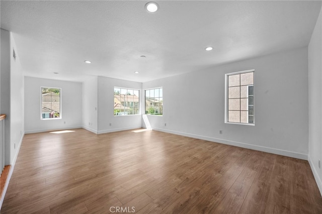 827 La Cadena Ln, Corona, CA 92879 - unfurnished living room with plenty of natural light, wood finished floors, and recessed lighting