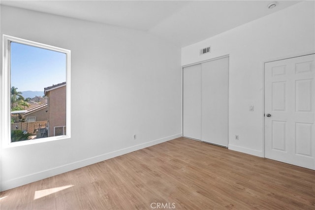 827 La Cadena Ln, Corona, CA 92879 - unfurnished bedroom with wood finished floors and a closet