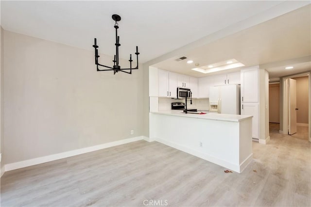 29 Stanford Ct Unit 93, Irvine, CA 92612 - kitchen featuring white fridge with ice dispenser, a chandelier, stainless steel microwave, light wood-type flooring, and light countertops
