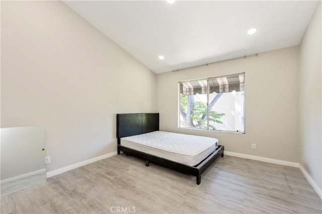 29 Stanford Ct Unit 93, Irvine, CA 92612 - bedroom with wood finished floors, vaulted ceiling, and recessed lighting