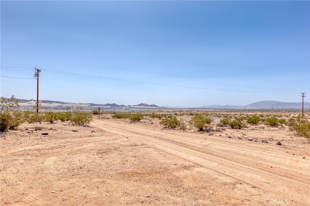 72082 Winters Rd Unit 29, Palms, CA 92277 - view of dirt / gravel road with view of desert, a mountain view, and a rural view