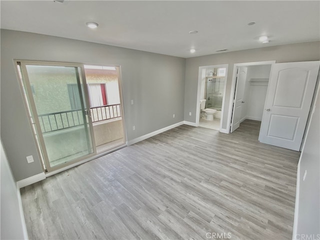 6545 Newlin, Whittier, CA 90601 - unfurnished bedroom featuring light wood-style flooring, ensuite bathroom, and a walk in closet