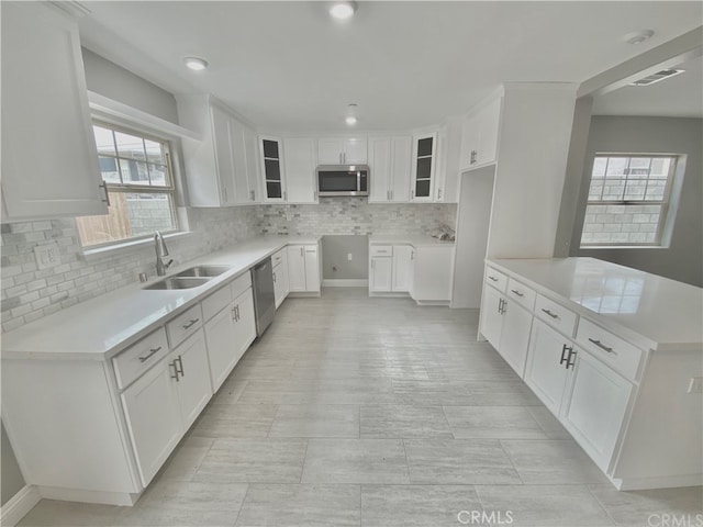 6545 Newlin, Whittier, CA 90601 - kitchen featuring stainless steel appliances, decorative backsplash, glass insert cabinets, white cabinetry, and light countertops