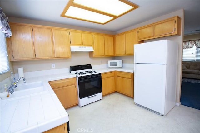 21295 Wisteria St, Apple Valley, CA 92308 - kitchen featuring white appliances, under cabinet range hood, tile counters, and light floors