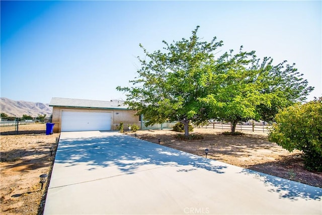 21295 Wisteria St, Apple Valley, CA 92308 - view of front of home featuring driveway, a garage, and a mountain view