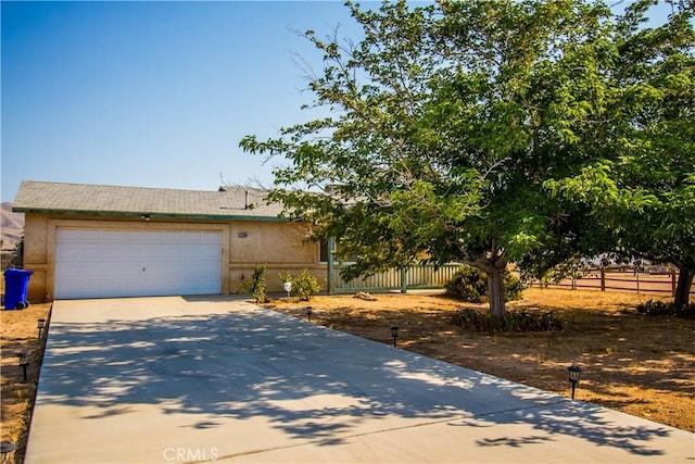 21295 Wisteria St, Apple Valley, CA 92308 - view of front of home with concrete driveway, a garage, and stucco siding