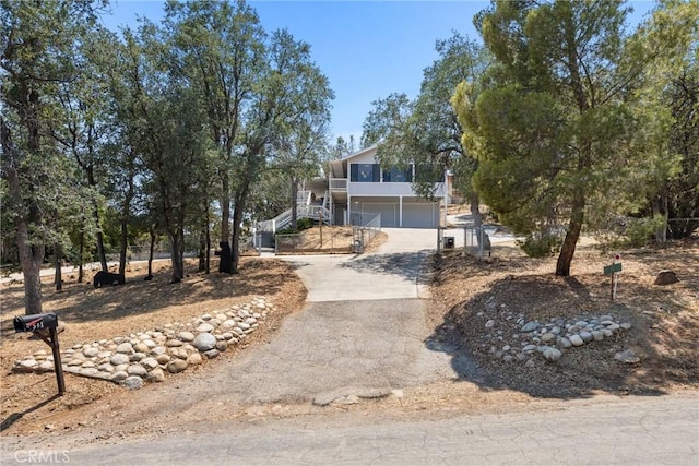 501 Old State Rd, Wofford Heights, CA 93285 - view of front of house featuring driveway, stairs, an attached garage, and stucco siding