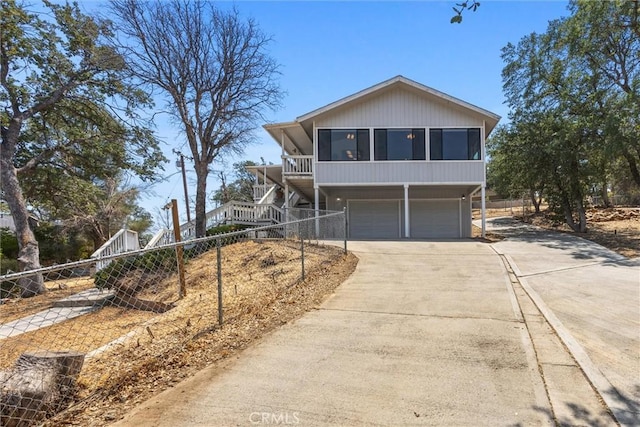 501 Old State Rd, Wofford Heights, CA 93285 - view of front facade with stairs, an attached garage, driveway, and a sunroom