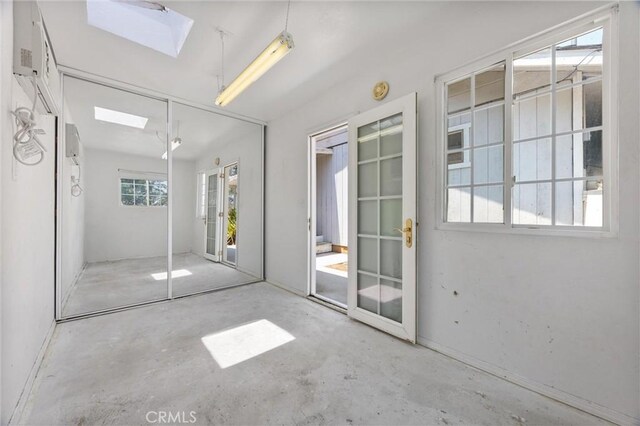 501 Old State Rd, Wofford Heights, CA 93285 - unfurnished bedroom featuring a skylight, unfinished concrete flooring, a closet, and access to exterior