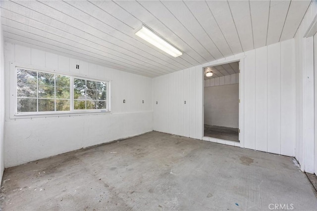 501 Old State Rd, Wofford Heights, CA 93285 - empty room with wood ceiling, wooden walls, and unfinished concrete flooring