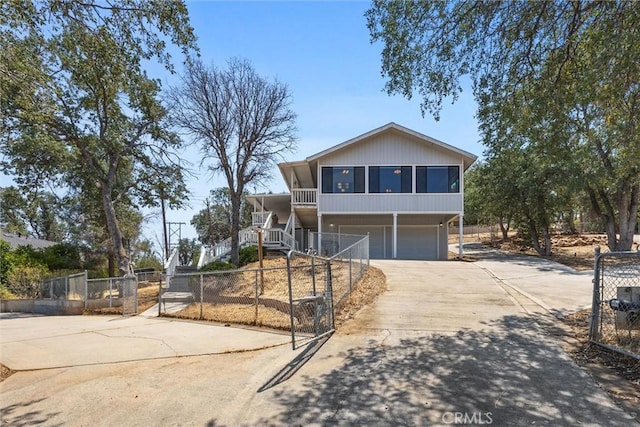 501 Old State Rd, Wofford Heights, CA 93285 - view of front of house featuring driveway, a garage, stairway, and a sunroom