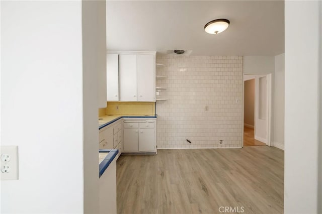 473 W 17th St, San Pedro, CA 90731 - kitchen featuring white cabinetry, light wood-style flooring, open shelves, tile walls, and light countertops