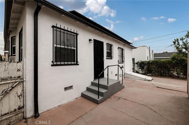473 W 17th St, San Pedro, CA 90731 - view of exterior entry featuring stucco siding and a patio