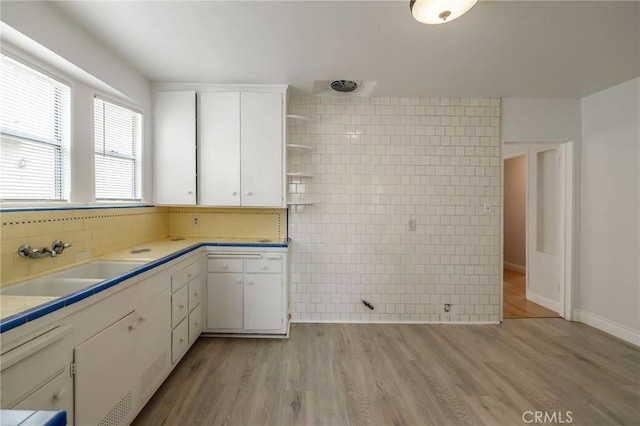 473 W 17th St, San Pedro, CA 90731 - kitchen with light countertops, white cabinets, open shelves, and light wood finished floors
